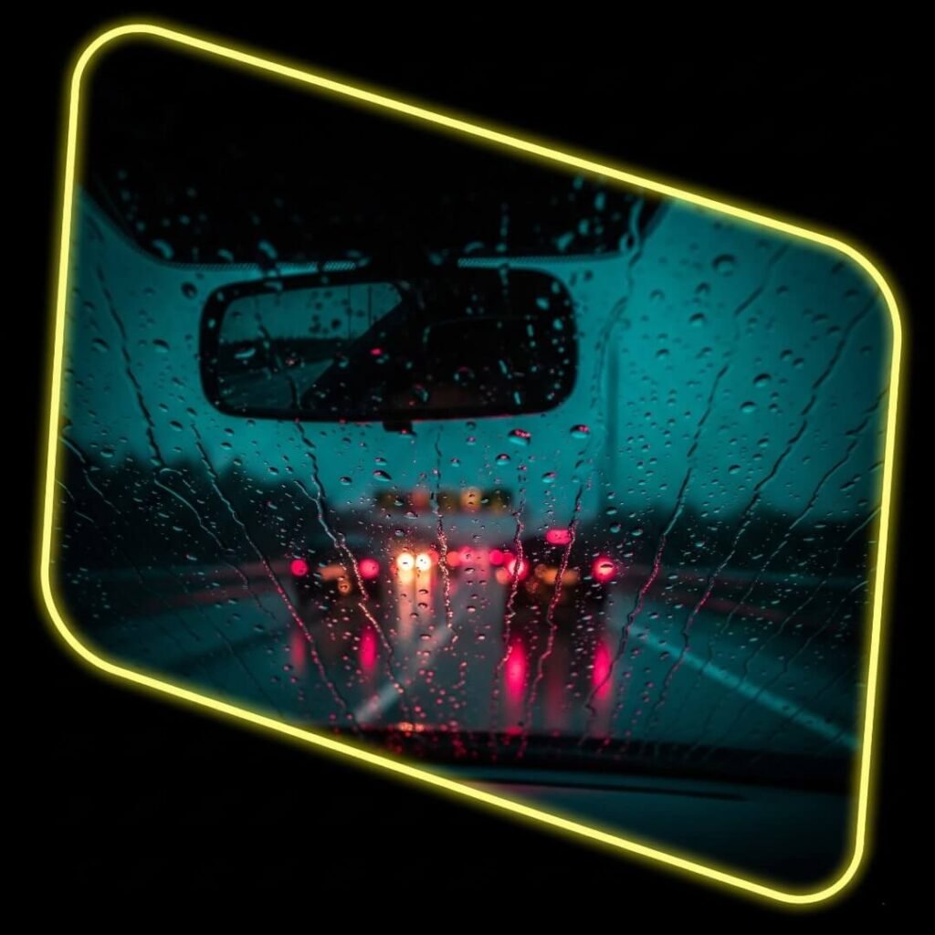 A tilted view of a dash cam filming a rainy highway at dusk.