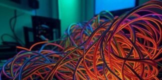 How to Build an Affordable Gaming Setup from Scratch Tangled feet, glowing RGB fans, dropped screws, budget PC build fail in neon greens.