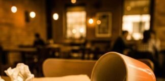 Best Budget Smartwatches That Do More Than Just Tell Time A vintage-style photo of a smartwatch, spilled latte, and a notebook.