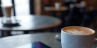 iPad Pro Review: A Laptop Replacement or Overpriced Tablet? Shiny iPad Pro, spilled latte, crumpled notebook with app doodles, pixelated spaceship on messy coffee table.