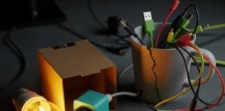 How to Turn Your House into a Smart Home on a Small Budget A cluttered desk with gadgets, a smart plug, and a sticky note.